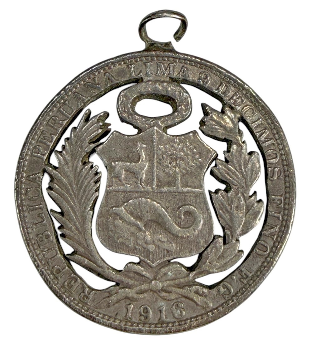 1916 Un Sol Peruvian Silver Coin Hand Cut Pendant: 1916 Peruvian Un Sol coin crafted into a pendant and with a hand cut openwork design, retaining its original central motifs including the standing Liberty figure and peruvian coat of arms. Diameter is