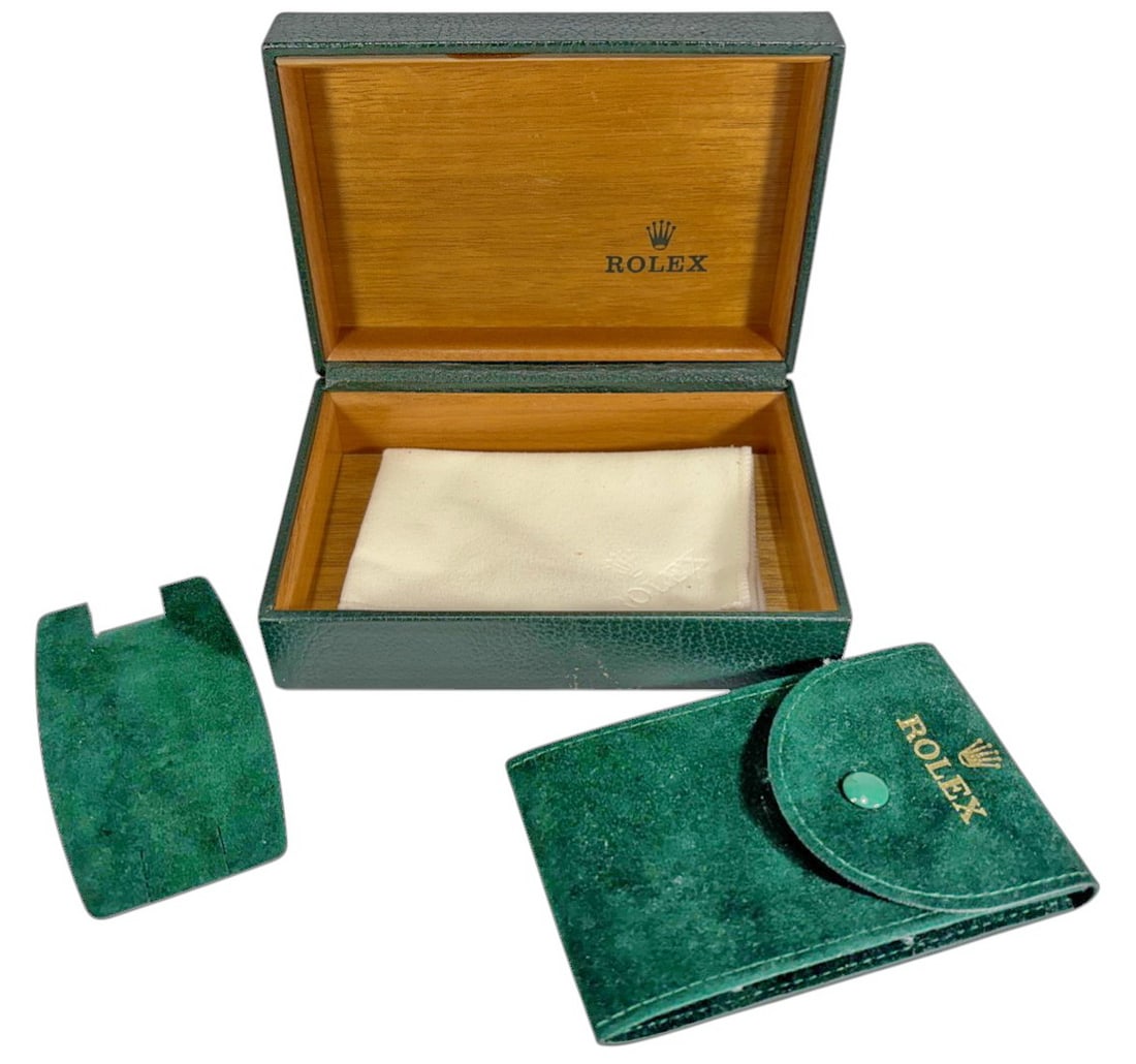 1970/80' Rolex Green Leather Presentation Box: Rolex Geneva green leatherwatch presentation box set featuring the classic textured leather exterior with gold Rolex crown logo and fitted wooden interior. Dimensions: 2 X 5.75 X 4 in. Condition: