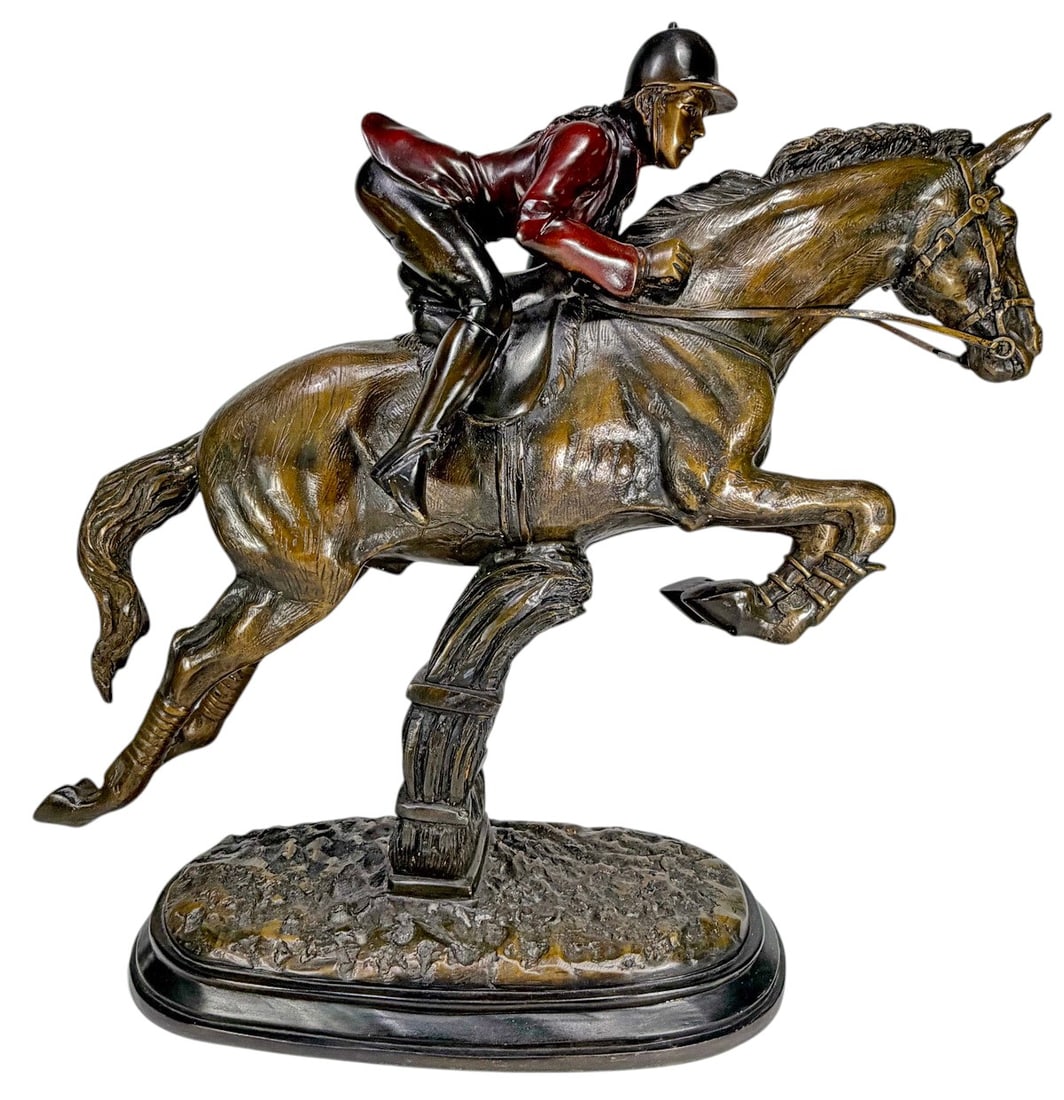 Large 20th C. Bronze Jockey Riding Horse Sculpture: 20th century bronze sculpture depicting a jockey riding a horse in jumping position. Two-tone patinated finish with polychrome accents. Mounted on an oval base with textured ground. No visible signatu