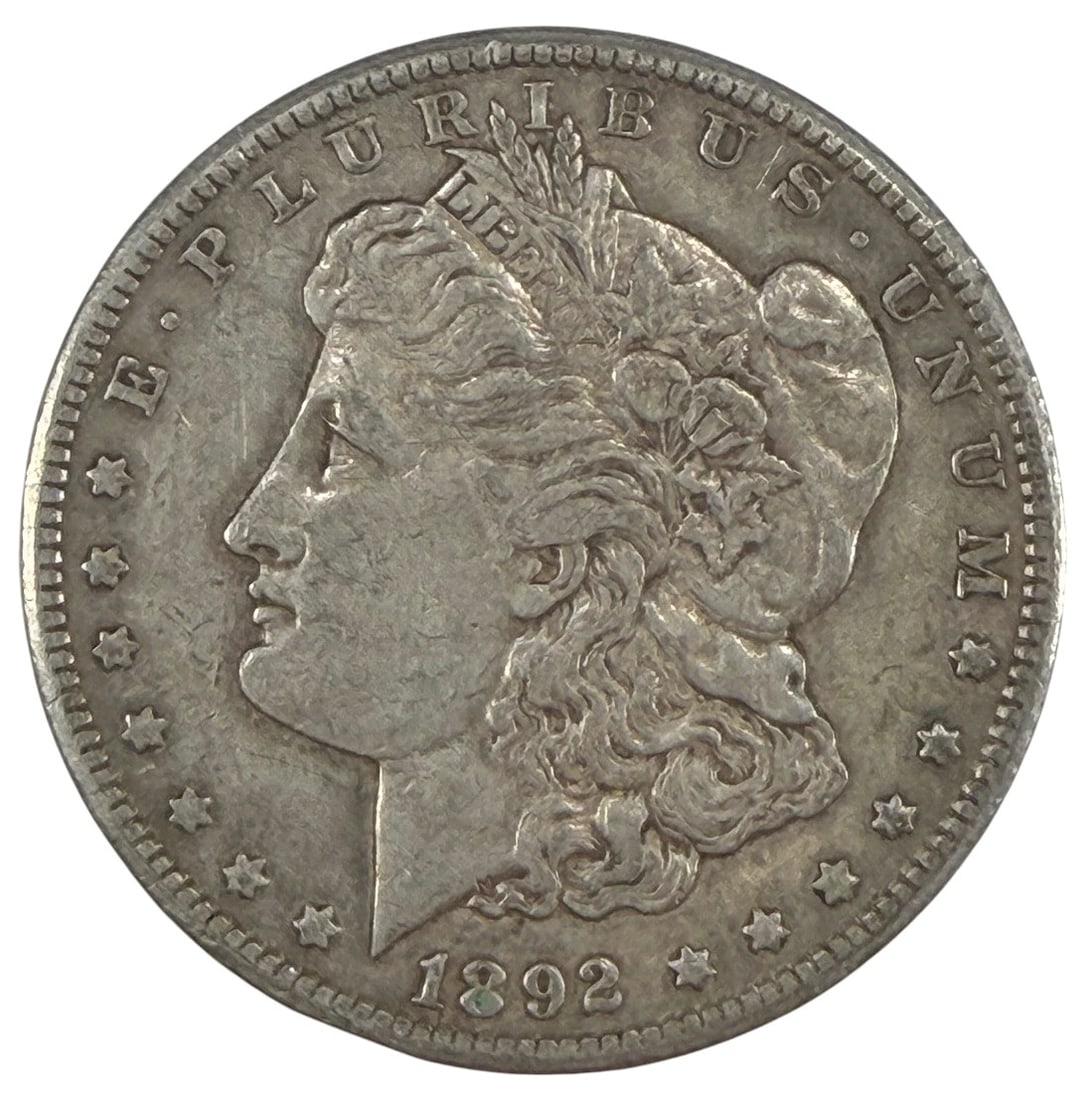 1892 CC Morgan Silver Dollar Coin Carson City: United States Mint, Morgan silver dollar dated 1892 CC, approximately 1.5 inches diameter, 26.5 grams, circulated, 90 percent silver, desirable Carson City issue. Condition: Good overall condition hav