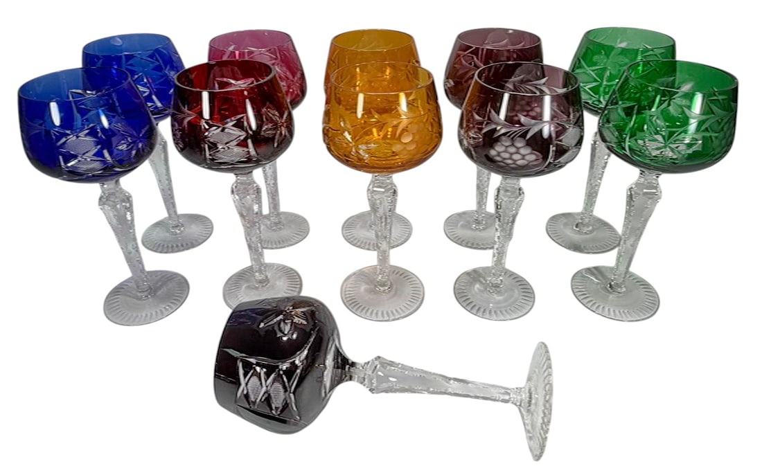 Multi Color Cut To Clear Crystal Wine Glasses 9pcs: Set of nine multicolor cut to clear crystal wine glasses, including blue, green, amber, cranberry, and amethyst tones, rounded bowls with cut grape and leaf motifs, faceted clear stems, and radial cut
