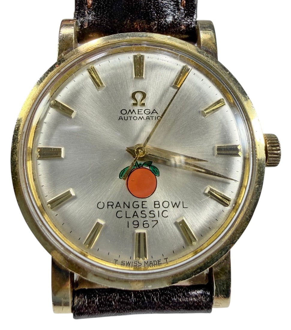 1967 Omega Automatic Orange Bowl Classic Watch: Omega, 1967 Orange Bowl Classic automatic wrist watch, silver tone dial with logo, 10K gold filled case, leather strap, approximately 1.25 inch diameter, commemorative example. Condition: Good overall