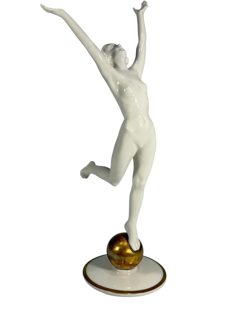 Hutschenreuther Porcelain Dancer Sculpture 8.5": Porcelain figure by Hutschenreuther, Kunstabteilung Selb, depicting a dancer in dynamic pose standing on a gilt sphere. White glazed finish with gold accents. Factory mark present on underside along w