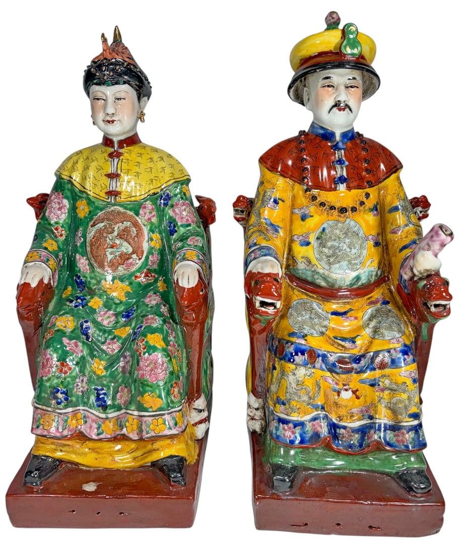 Pair Chinese Famille Rose Ceramic Dignitary Figure: Pair of Chinese famille rose glazed ceramic figures depicting seated male and female dignitaries in elaborate court dress, richly decorated with floral motifs, dragon medallions and polychrome enamel 