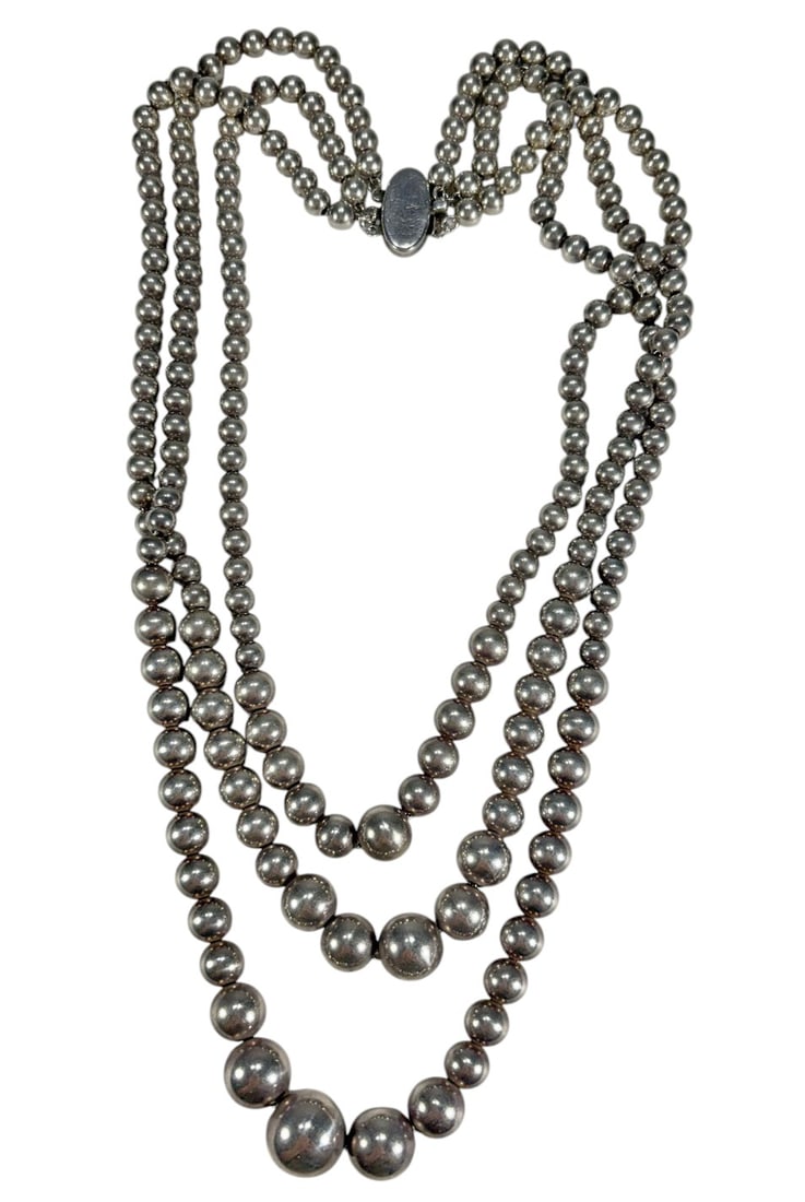 Sterling Silver Bead Necklace w/ Oval Clasp 80 g: Sterling silver bead necklace composed of graduated spherical beads increasing in size toward the center. Features an oval clasp. Marked '925' on the clasp. Classic design with polished finish. Piece 