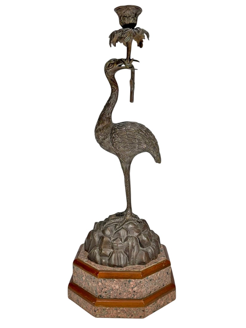 Bronze Crane Candlestick with Granite Base 22": Bronze crane form candlestick, modeled as a standing crane holding a foliate candle cup in its beak, with detailed featherwork and naturalistic form, mounted on a sculpted base over an octagonal grani