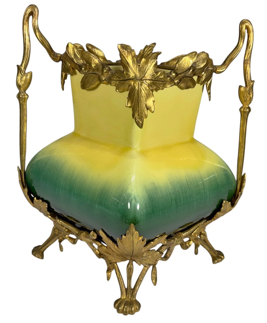 Art Nouveau Majolica Jardiniere w/ Ormolu Mounts: Art Nouveau majolica jardiniere, bulbous form with square flared rim, yellow to green gradient glaze, gilt ormolu mount with foliate motifs, scrolling handles and raised feet, organic design. Dimensio