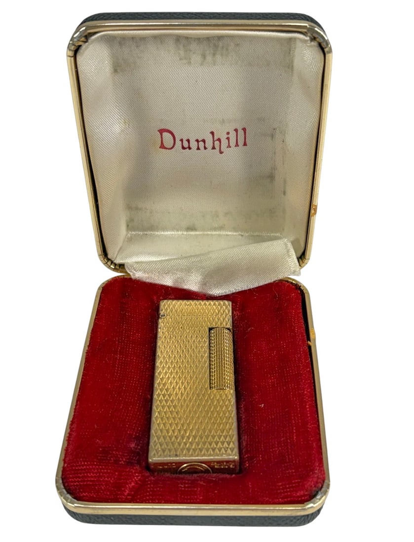 Dunhill Gold Tone Butane Lighter In Original Case: Dunhill gold tone butane lighter with original fitted case.Rectangular lighter with engine turned diamond pattern and side roller striker, marked 'Dunhill' and 'Made in Switzerland' on its base, paten