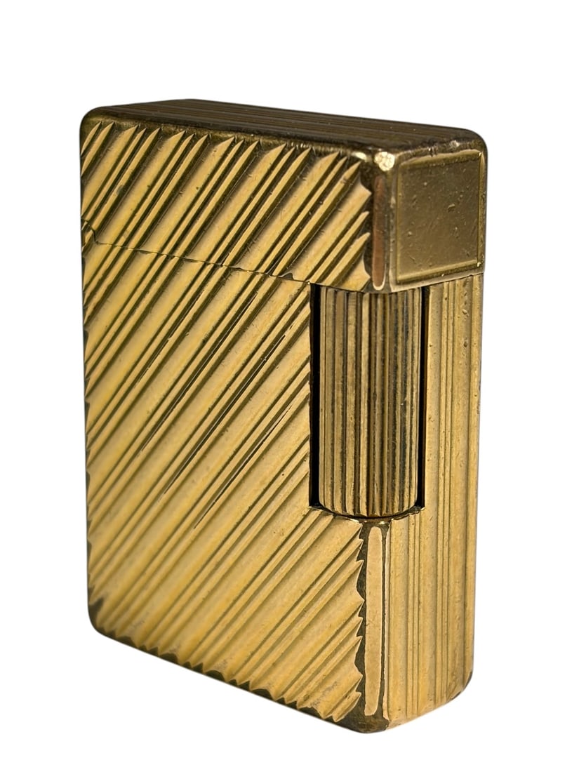 S.T. Dupont Gold Tone Lighter Made In France: S.T. Dupont gold tone lighter, Ligne 1 style with diagonal line pattern, rectangular form with fluted roller striker and hinged lid, underside is marked 'S.T. Dupont Paris Made in France,' serial numb
