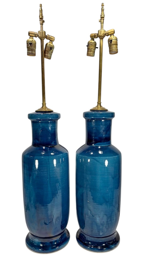 Pair Of Blue Glazed Ceramic Table Lamps w/ Brass: Pair of blue glazed ceramic table lamps with brass double sockets, tall cylindrical bodies with high gloss blue glaze and tonal variation, mounted with brass stems and dual adjustable fittings. Each m