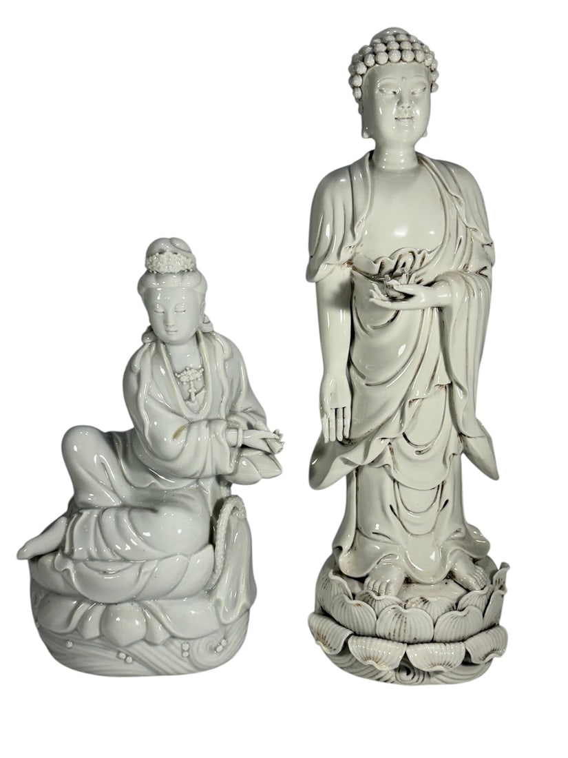 Chinese Blanc De Chine Porcelain Figures 2pc LOT: Pair of molded blanc de chine porcelain figures including seated Guanyin on lotus base and standing Buddha figure on lotus pedestal, with flowing robes and beaded hair detail, one with fitted presenta