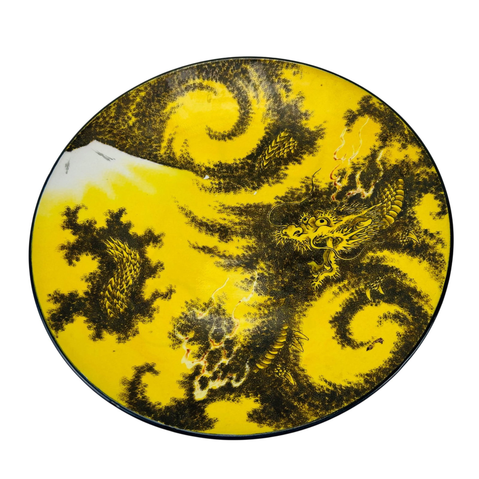 Chinese Yellow Glaze Dragon 18" Porcelain Charger: Chinese porcelain charger featuring a yellow ground decorated with a coiled dragon amid cloud and flame motifs. The wide shallow form has a dark rim edge, with the underside decorated in blue with sty