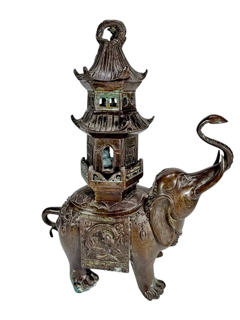 Asian Style Bronze Elephant Pagoda Incense Burner: Cast bronze figural incense burner in the form of an elephant with raised trunk, supporting a multi tiered pagoda tower with pierced windows and removable top, body decorated with relief panels featur
