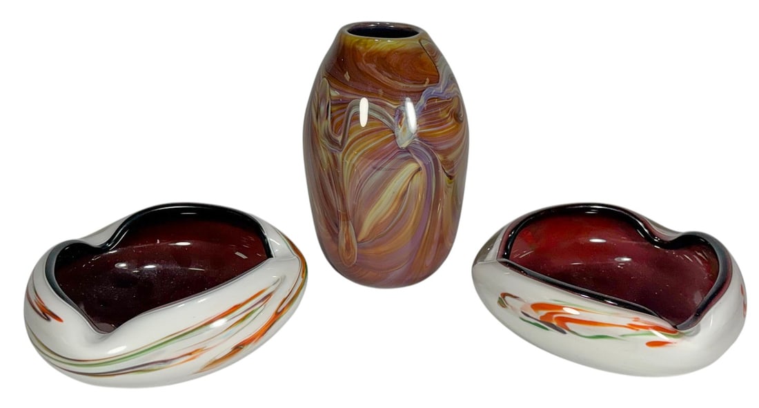 Art Glass Signed Vase & Two Ashtrays 3pc LOT: Group of three art glass pieces including a hand blown vase with multicolor swirling pattern in amber, purple and cream tones, together with two freeform ashtrays having deep maroon interiors and whit