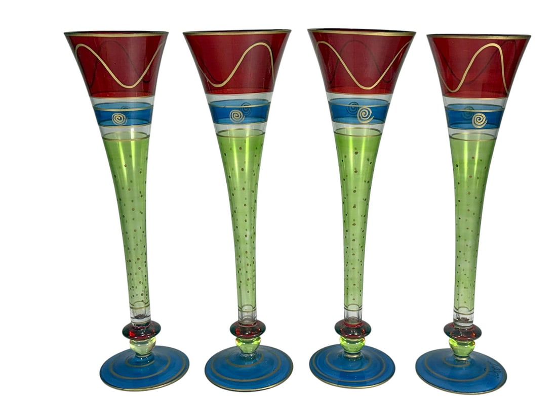 Pier 1 Hand Painted Glass Champagne Flutes 4pc LOT: Set of four hand painted champagne flutes with multicolor design including red bowls, blue bands with spiral motifs, green stems with gilt dots, and blue bases with gold trim. Each piece measures appr