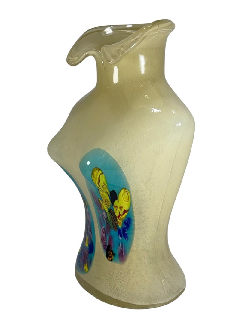 Art Glass Female Torso Vase w/ Applied Decoration: Hand blown art glass vase in stylized female torso form with flared rim, cream ground with mottled texture, and applied multicolor abstract panels in blue, yellow, purple, and green. Dimensions: 12.25