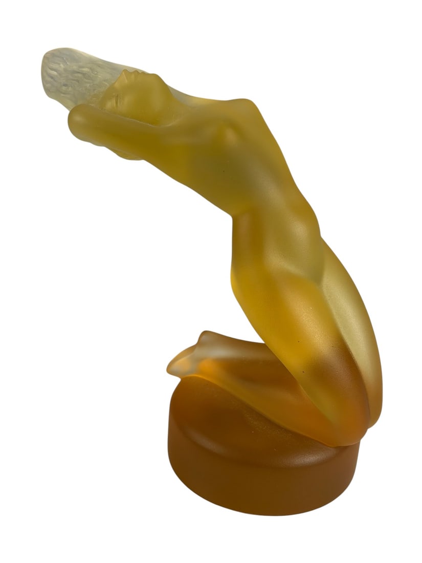 Lalique France Chrysis Amber Crystal Nude Figure: Amber crystal figure 'Chrysis' depicting a reclining female nude. Frosted and polished finish with flowing Art Deco lines, raised on an integrated base. Marked 'Lalique France.' Dimensions: 5.25 X 6 X