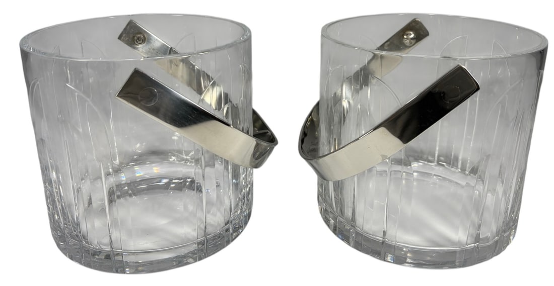 1960s' Cartier Crystal Octagon Ice Bucket 2pc LOT: Cartier pair of crystal ice buckets, cylindrical form with vertical cut decoration, heavy clear crystal bodies, stainless steel swing handles, marked Cartier and stainless steel, modernist mid century