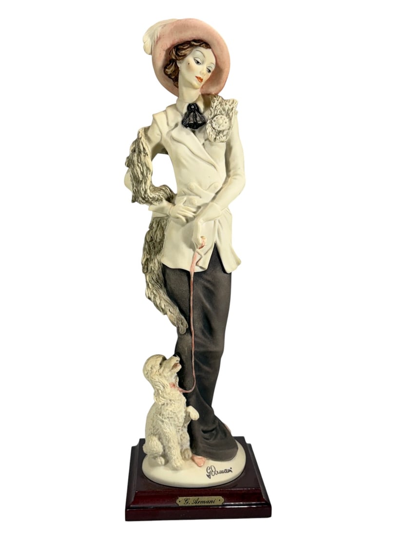 Giuseppe Armani Lady w/ Poodle Figurine # 394: Figurine by Giuseppe Armani depicting a lady holding a poodle on leash. Mounted on a wooden base with metal name plaque reading 'G. Armani.' The underside shows the scripted Armani signature and 'Flor