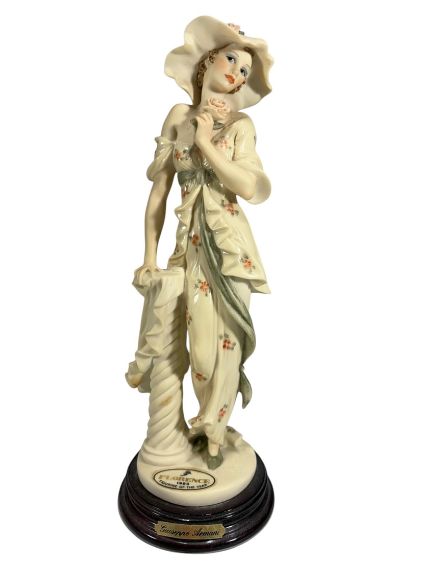 Giuseppe Armani Secret Love Figurine Italy, 1993: Figurine titled 'Secret Love' by Giuseppe Armani, Florence, Italy, 1993. Female figure holding a rose, wearing a wide-brim hat and floral decorated dress, mounted on original wooden base. Front base r