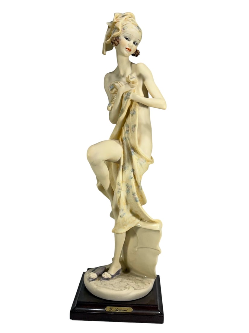 Giuseppe Armani Bath Lady Figurine Dated 1991: Figurine depicting a standing female figure drying herself with a towel, modeled in a naturalistic pose with one leg raised. The figure wears a head wrap and is shown with finely detailed facial featu