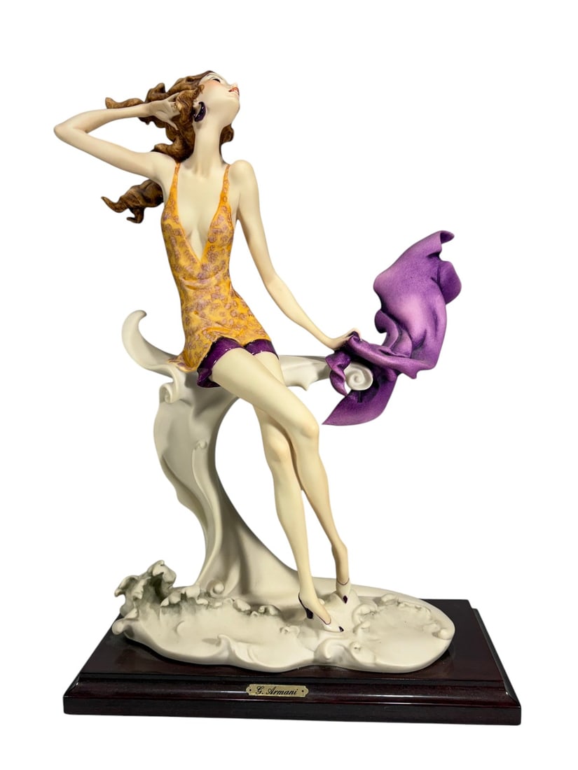 Giuseppe Armani Seashore Summer 540C Figurine: Giuseppe Armani figurine titled 'Seashore - Summer,' model 540C. Depicts a seated female figure in a yellow swimsuit holding a flowing purple wrap, positioned on a stylized wave-form base. Mounted on 