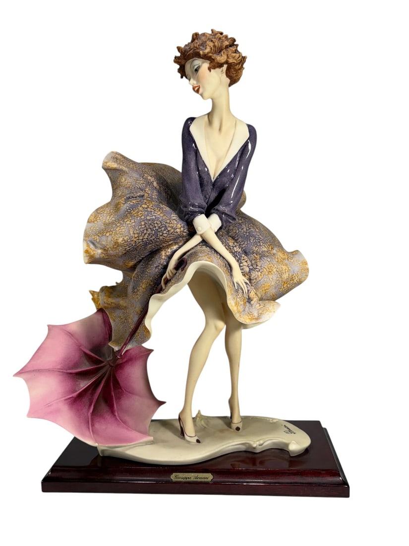 Giuseppe Armani Umbrella Autumn Figurine 0541C: Giuseppe Armani figurine titled 'The Umbrella Autumn,' model #0541C. Depicts a female figure with windswept dress holding a pink umbrella, raised on original wooden base with brass nameplate to front 