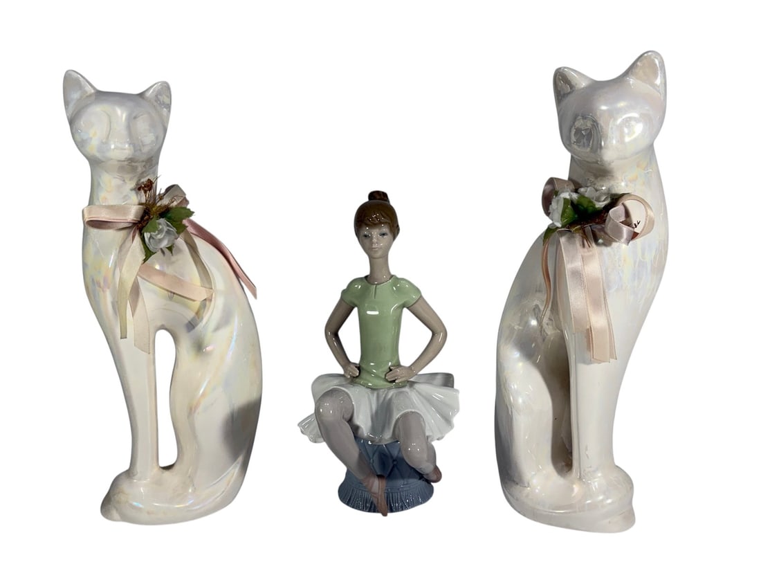 Lladro Spain Ballerina Laura & Cat Figures 3pcs: Three-piece lot of Lladro porcelain figurines including a seated ballerina in green dress (model 'Laura' #1360) and two stylized cat figures with iridescent glaze and decorative ribbon accents. All ma