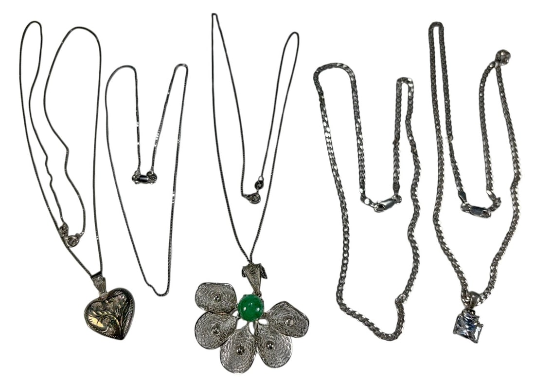 Sterling Silver 925 Necklaces & Pendants 5pc LOT: Group of five sterling silver necklaces and pendants. Includes a necklace with square clear stone pendant on curb-link chain, an engraved heart-shaped locket pendant, a large filigree flower-form pend