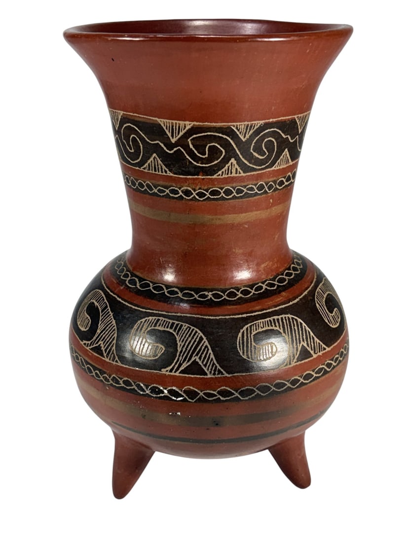 Possibly Tony Dad Tripod Pottery Vessel Vase: Handcrafted pottery vase, possibly by Tony Dad, with tripod base, globular body, and flared rim. Decorated with incised and painted black geometric motifs on a terracotta ground in a pre-Columbian ins