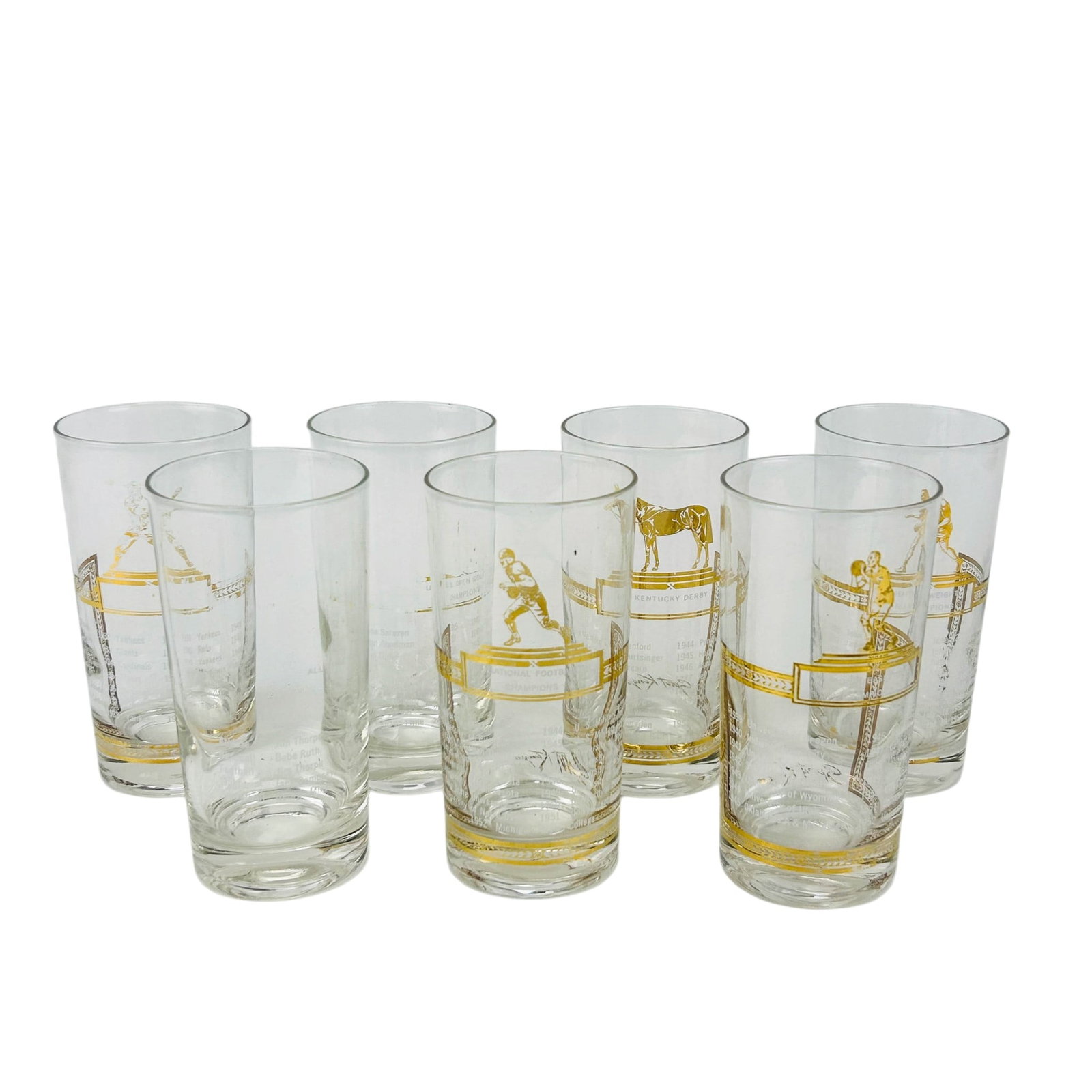 Sports Kings & Kentucky Derby Gold Decor Tumblers: Lot of seven clear glass tumblers featuring gold tone decorations with various sports figures including football, baseball, horse racing, boxing, and golf. Each glass is decorated with titled scenes s