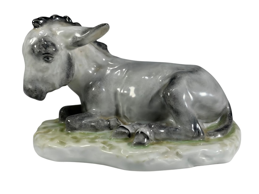 Herend Hungary Hand Painted Porcelain Donkey #5275: Herend hand-painted Hungarian porcelain figure depicting a seated donkey with gray glazed decoration on a naturalistic green accented base. Underside marked Herend, Handpainted, and impressed model