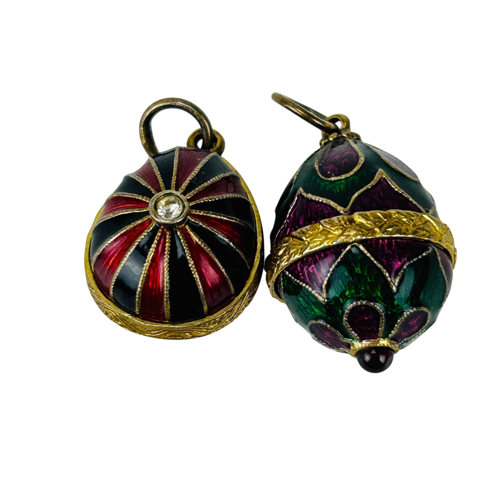 Faberge Style Enamel Gilt Silver 925 Egg Pendants: Pair of Faberge style enamel egg necklace pendant charms fashioned in sterling silver with gilt detailing. One pendant features green and magenta floral decoration, the other with alternating red and