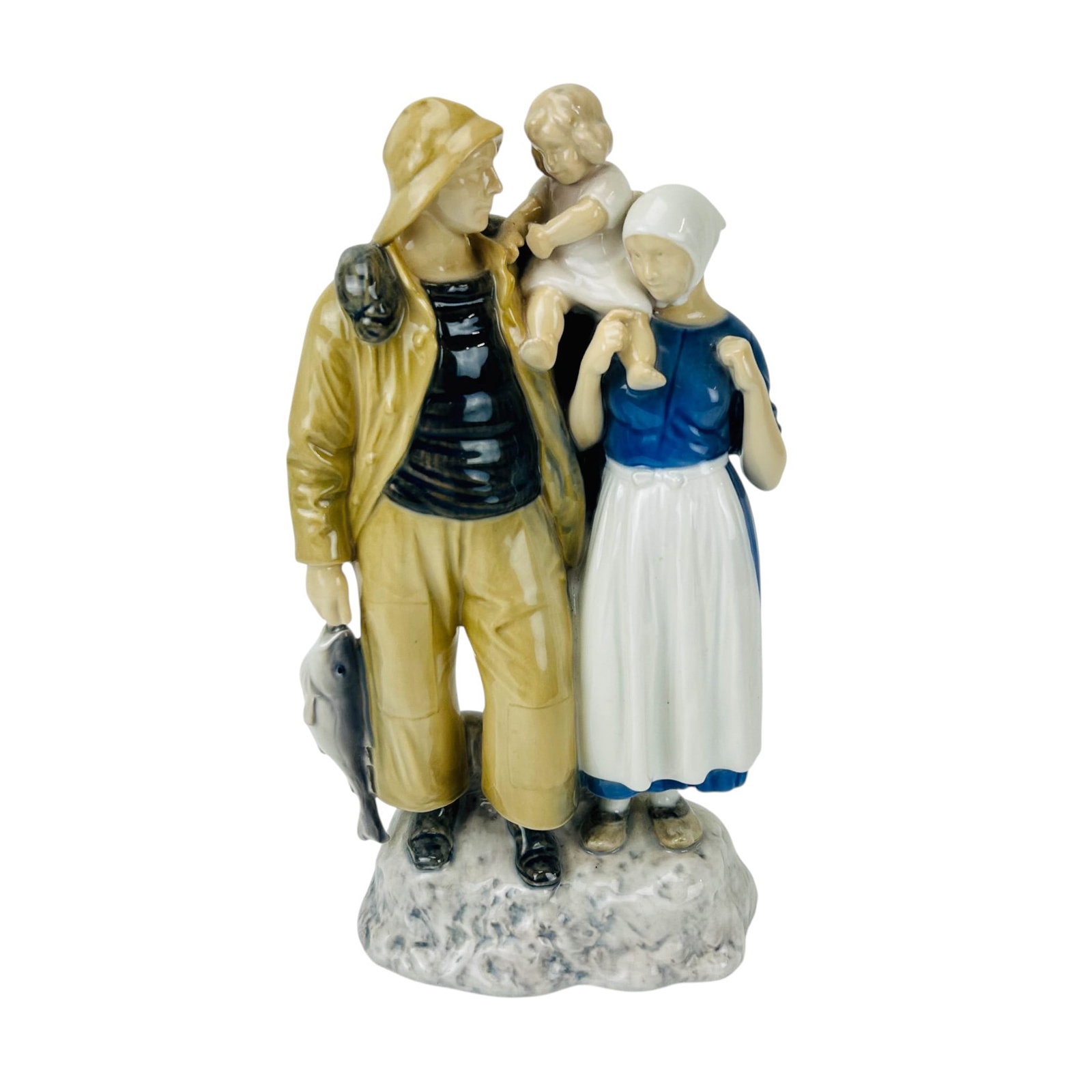 Bing & Grondahl Fisherman's Family # 2025 Figurine: Bing & Grondahl (B&G) Denmark porcelain figural group titled Fishermans Family, model 2025, designed by Axel Locher (Danish, 18791941). Depicts a fisherman holding a fish beside a woman carrying a chi