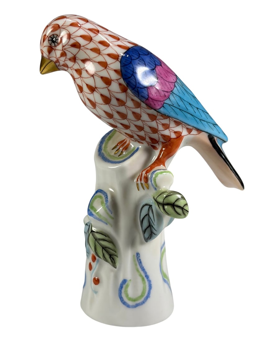 Herend Hungary Hand-Painted Porcelain Parrot Fig: Herend hand-painted porcelain parrot figure, model 5046, depicting a stylized bird perched on a tree stump base with the makers signature rust fishnet decoration, accented with polychrome enamel detai