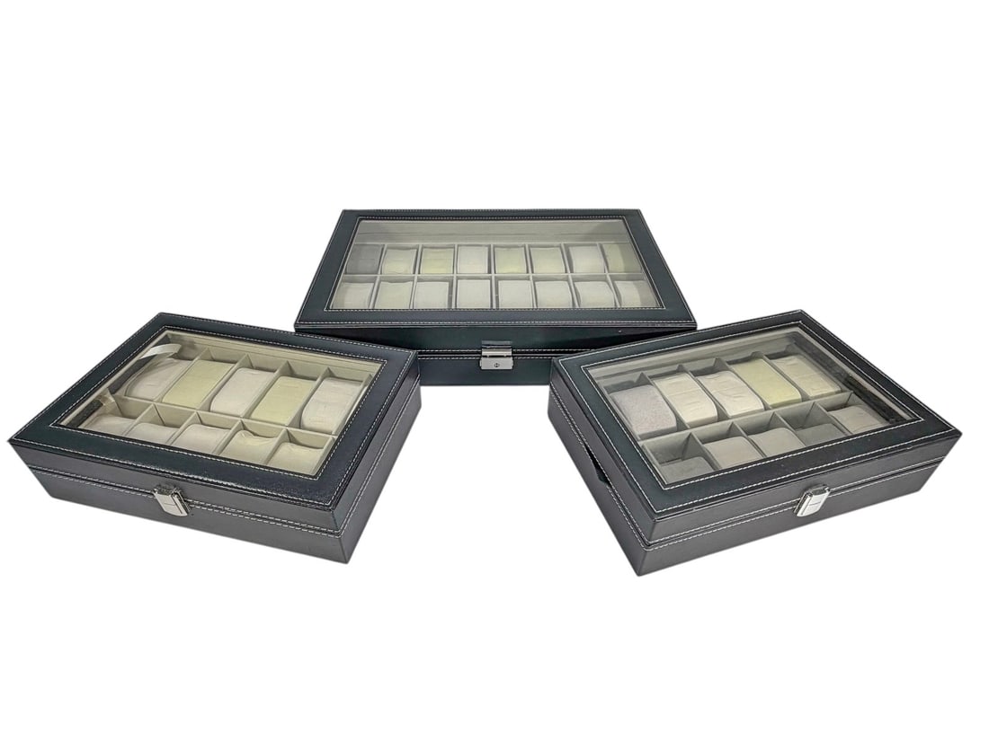 Watch Display & Storage Cases w/ Lid 3pc LOT: Set of three watch display and storage cases with silver-tone metal hardware, glass-top lids, and faux leather exterior with white contrast stitching. Interiors fitted with removable faux leather watc