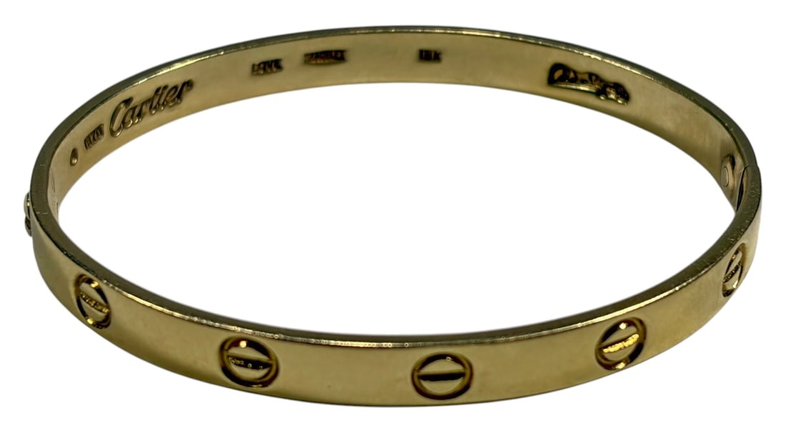 Vintage 1970 Cartier Aldo Cipullo Love Bracelet: Vintage Cartier Love bracelet designed by Aldo Cipullo, dated 1970. Crafted in 18 karat yellow gold with the iconic screw motif design and oval hinged form. Interior bears Cartier signature with 1970