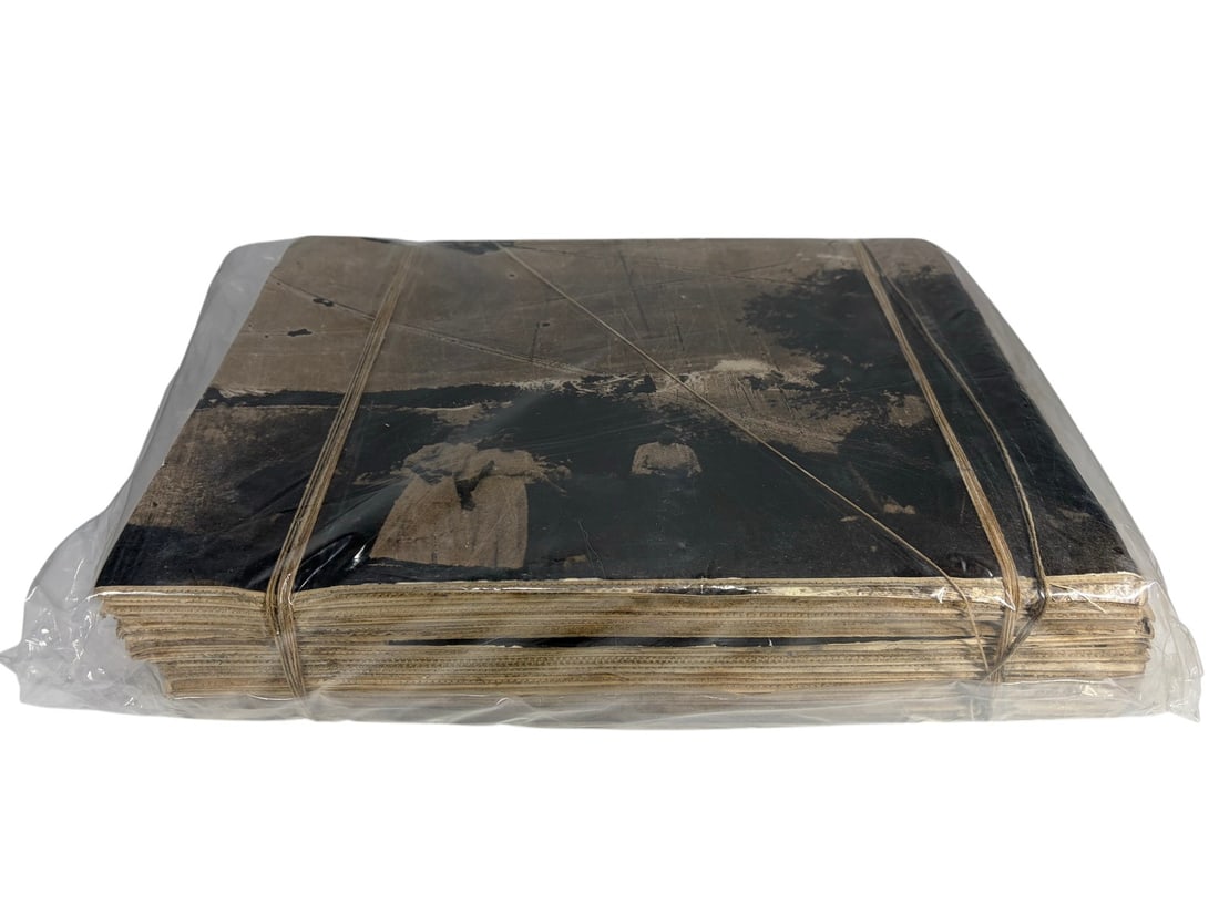 J. M. Fors 'Atado de Memorias' Package, 2000: Mixed media assemblage by J. M. Fors titled 'Atado de Memorias,' consisting of bundled sepia-toned photographic paper sheets wrapped in cord and enclosed in protective plastic. Dimensions: 12 X 15.5 X
