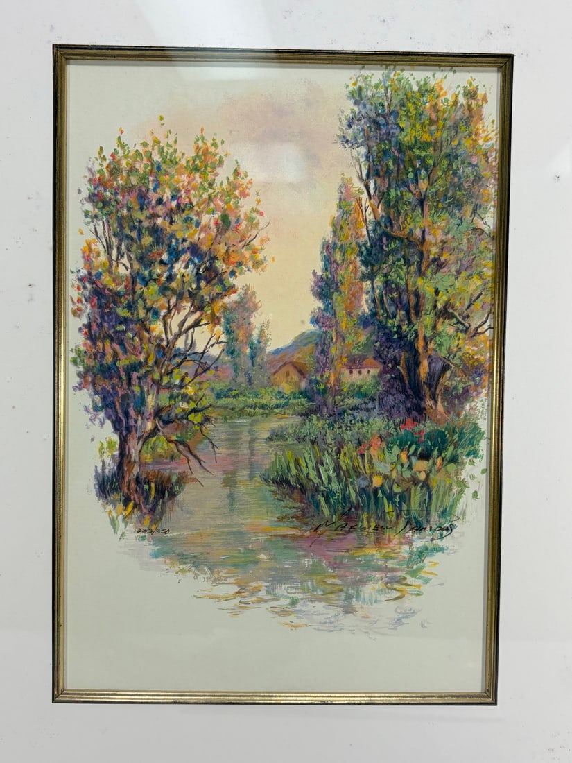 Signed River Landscape Giclee Framed Print: Framed giclee print depicting a calm river bordered by colorful trees and flowering vegetation with cottages in the background. Presented under mat in a gilt-tone decorative frame. Framed giclee print