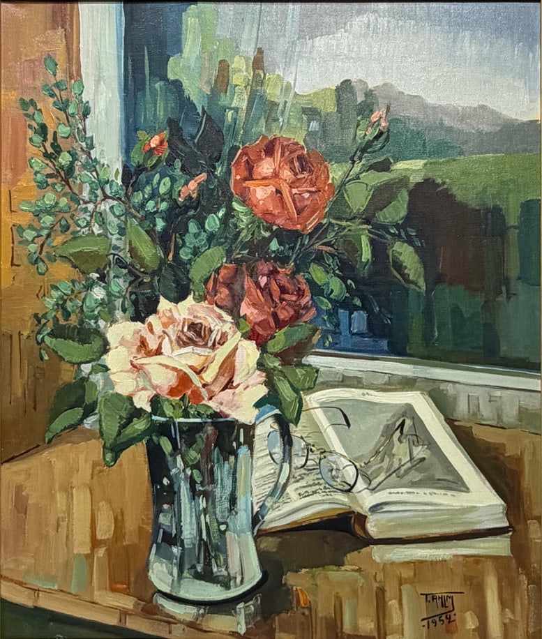 T.R. Ahlm Floral Still Life Oil Painting on Canvas: Oil painting on canvas depicting a floral still life with roses in a glass vase beside an open book, set against a landscape view. Signed lower right T. R. Ahlm and dated 1952. Verso bears inscription