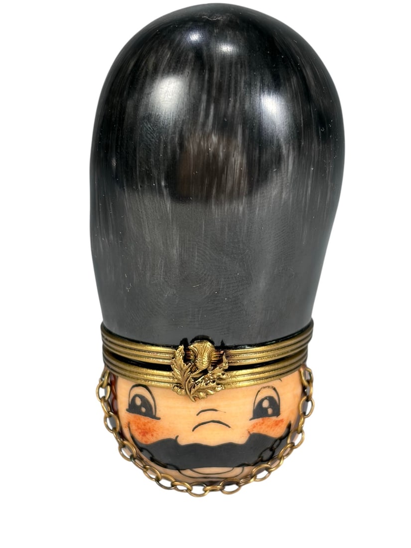 Rochard Limoges France Soldier Head Trinket Box: Rochard hand-painted Limoges porcelain trinket box modeled as a soldiers head with tall bearskin-style hat, moustache, and decorative gilt-tone mount. Marked Peint Main Limoges France Rochard. Dimensi