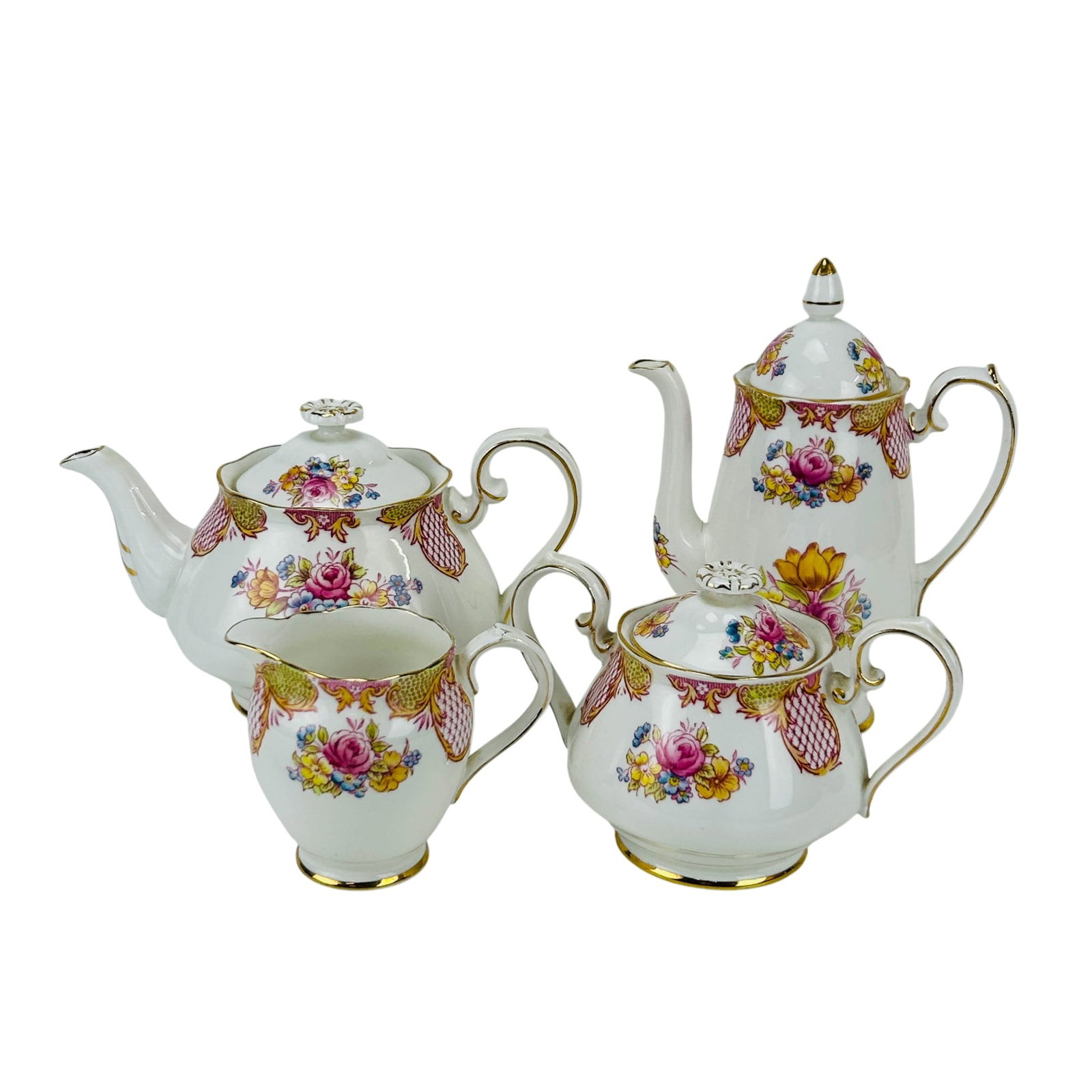 Roslyn Delamere Coffee Tea Pot Creamer and Sugar: Roslyn English Fine Bone China tea service in the Delamere pattern, comprising coffee pot, teapot, covered sugar bowl, and creamer. Designed with a white ground with floral decoration and gilt accents