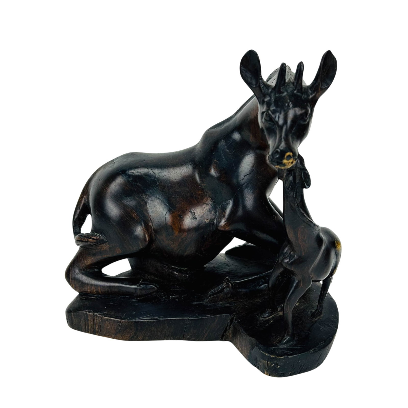 African Carved Hardwood Giraffe w/ Calf Sculpture: African carved ebonized hardwood sculpture depicting a seated giraffe with calf on integral base. Executed in dark stained wood with stylized elongated forms and carved detail. No apparent maker's mar