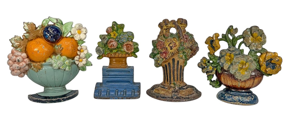 Cast Iron Figural Floral Basket Doorstops 4pc LOT: Group of four vintage cast iron floral and fruit basket form doorstops with hand-painted polychrome finishes. Includes examples depicting floral arrangements, fruit displays, and urn forms with