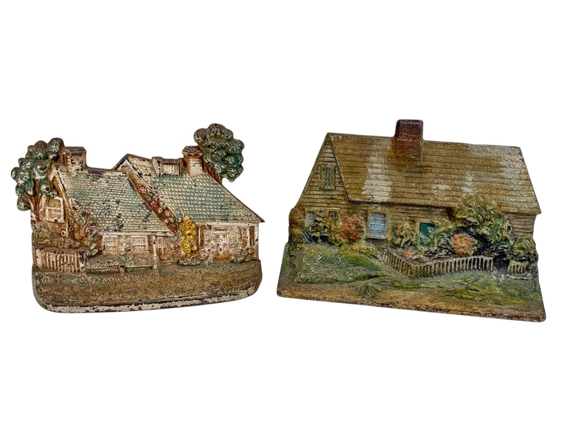 Cast Iron Figural Cottage House Doorstops 2pc LOT: Group of two vintage cast iron cottage house form doorstops with polychrome painted finishes. Includes one floral cottage example and one larger figural house example marked Eastern Specialty Mfg.