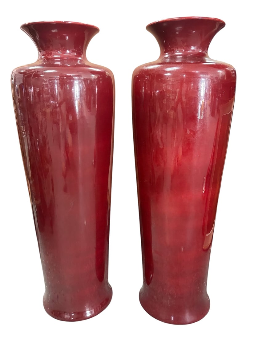 Large Red Glazed Porcelain Floor Vases Pair: Pair of oversized red glazed porcelain floor vases with tapered cylindrical form and flared rims. Each with glossy deep red finish and marked Italy to underside. Each measures approximately 40 inches