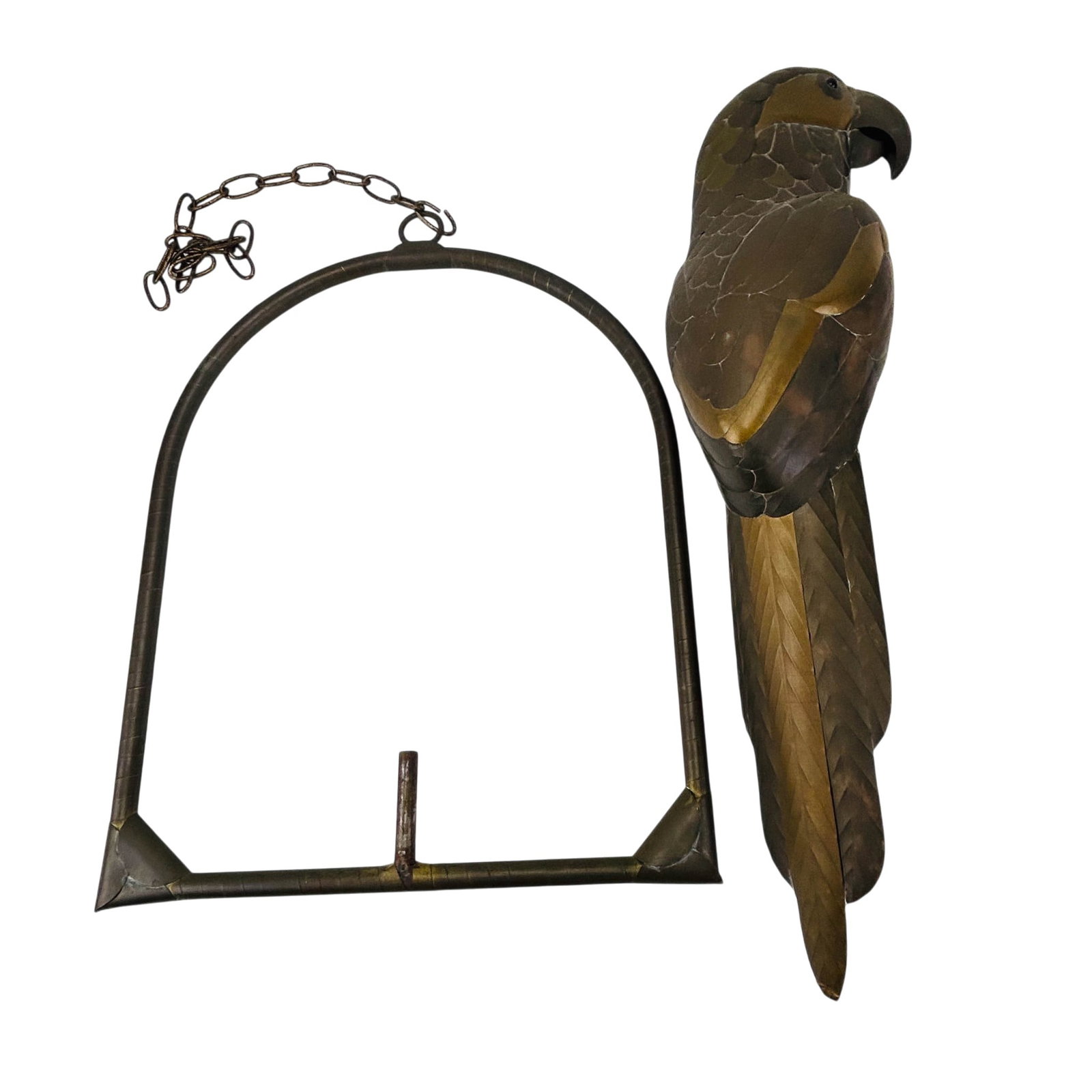 Bustamante Style Brass and Copper Parrot Sculpture: Mid century modern decorative mixed metal macaw parrot figural hanging sculpture mounted within a suspended swing form. The stylized bird features etched feather decoration with articulated hanging ch