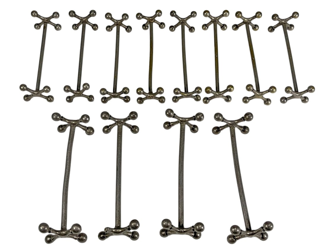 Vintage Mid Century Modern Knife Rests 12pc LOT: Group of twelve vintage knife rests in a mid-century modern atomic or jack-inspired design with rounded ball finials. Includes eight smaller unmarked silver-tone metal examples and four slightly large