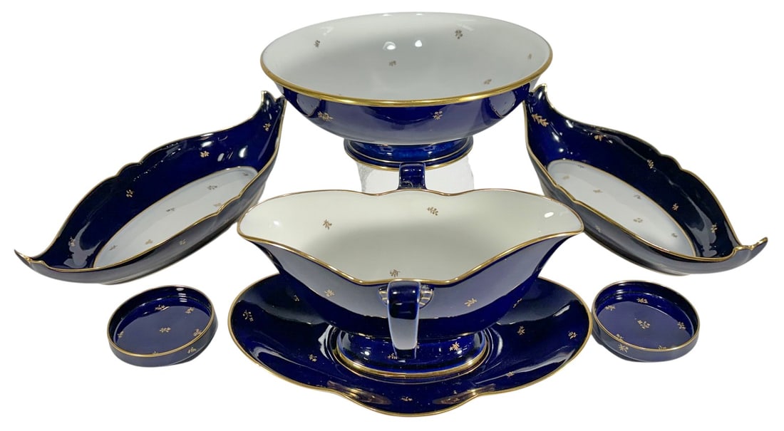 Sevres Style Cobalt Blue & Gilt Porcelain 7pc LOT: French Sevres style porcelain 7-piece serving group in cobalt blue and white with gilt trim and delicate gilt floral decoration. Includes a pedestal centerpiece bowl, double-handled gravy boat with at