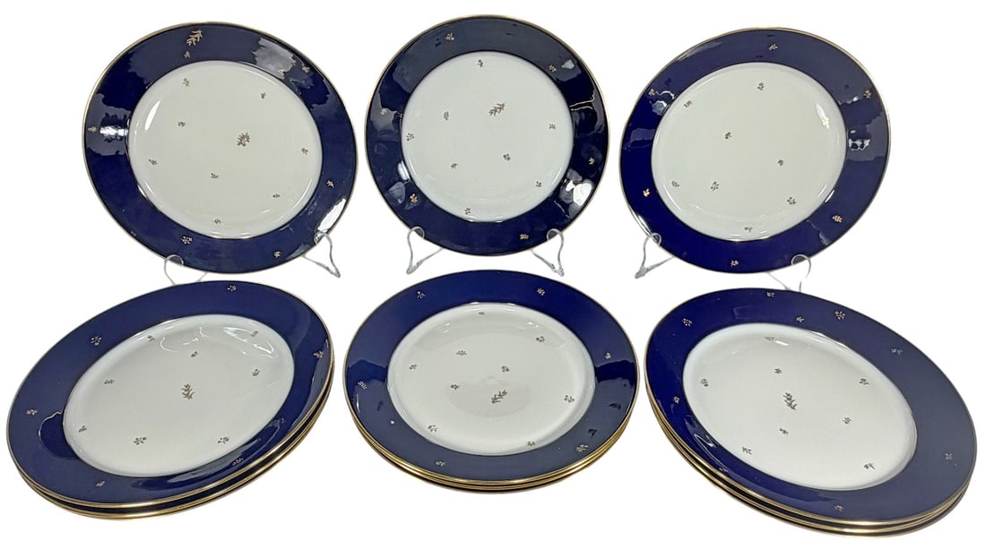 Sevres Style Cobalt Blue & Gilt Plates 12pc LOT: French Sevres style porcelain 12-piece plate group in cobalt blue and white with gilt trim and delicate gilt floral decoration. Marked Manufacture Nationale Dore a Sevres. Each plate measures 1 inch h